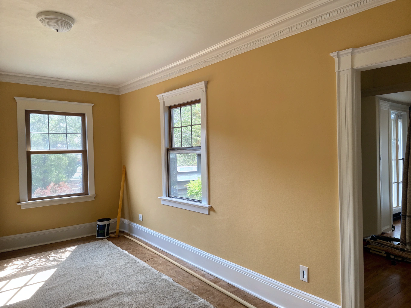 Professional painter applying smooth finish to interior wall